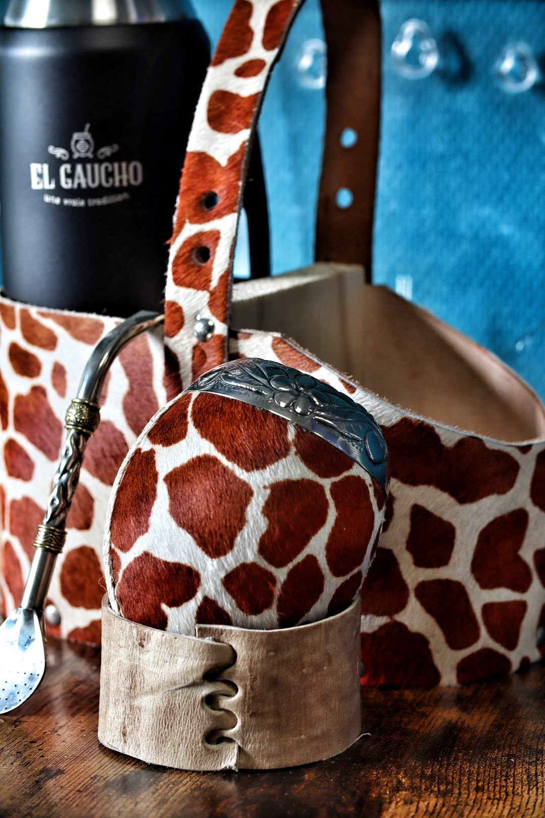 Gros plan sur la texture unique et l'élégance du cuir travaillé façon girafe enveloppant le maté.